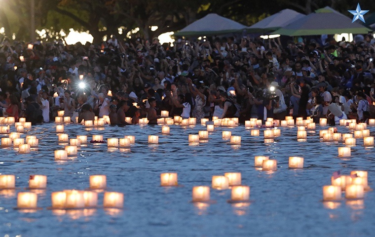 Lanterns float on the water at Ala Moana Beach Park